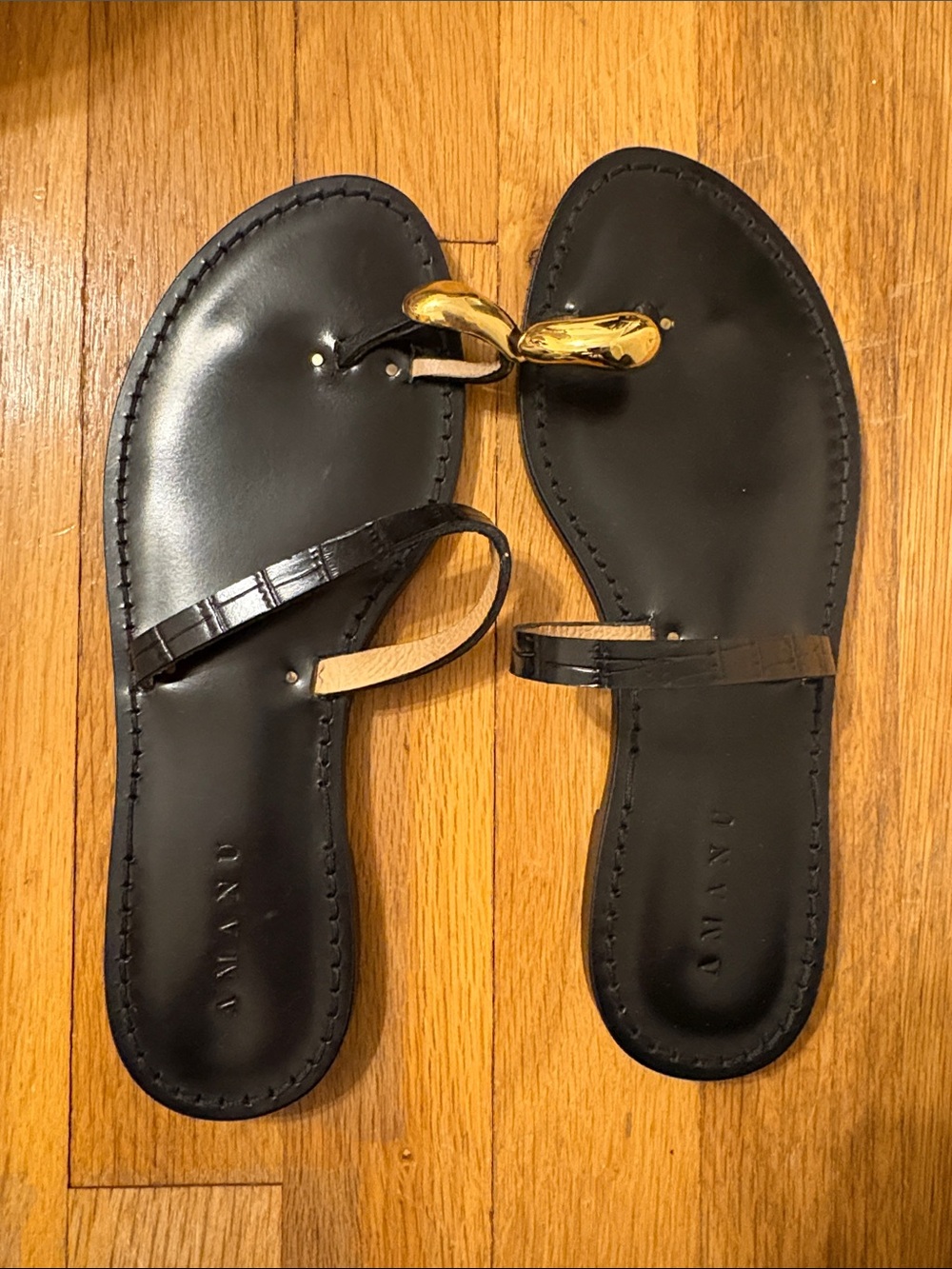 Amanu Kibera Black Leather Women's Toe-Loop Flat Sandals with Gold Accent